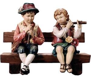 Flute players sitting on a bench