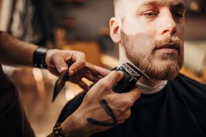 Photography Male barber cutting beard of client in barber shop, South_agency