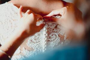 Art Photography Close-up of a bridesmaid buttoning up, corinafotografia, (40 x 26.7 cm)
