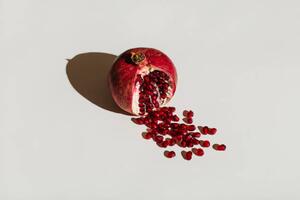 Art Photography ut pomegranate on a white background., Tanja Ivanova, (40 x 26.7 cm)