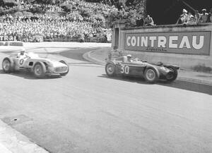 Photography Stiriling Moss in the mercedes and Eugenio Castellotti driving the lancia d50 passing the gasworks, 1955, (40 x 30 cm)