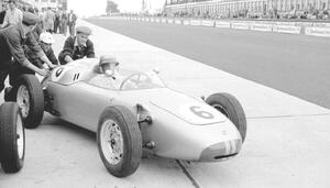 Photography Hans Herrmann in a porsche being pushed out of the pits, 1960, (40 x 22.5 cm)