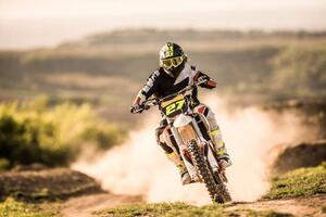 Photography Man on dirt bike racing on dirt road in nature., skynesher