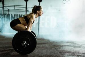 Photography Side view of athletic woman exercising, skynesher