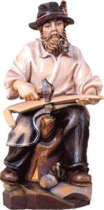 Farmer sitting woodcarving from lime wood