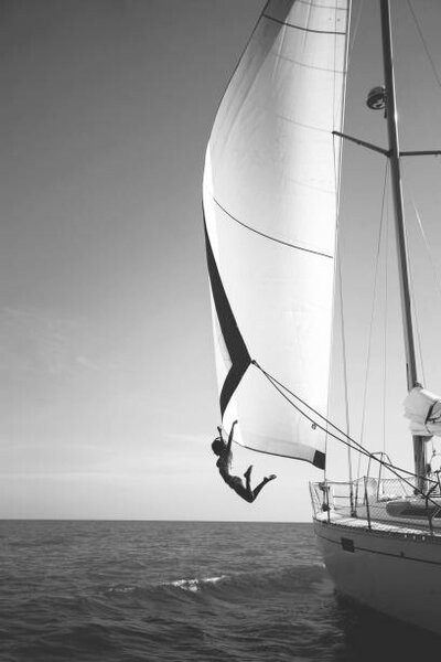 Photography Woman jumping from a yacht into the ocean., Mint Images