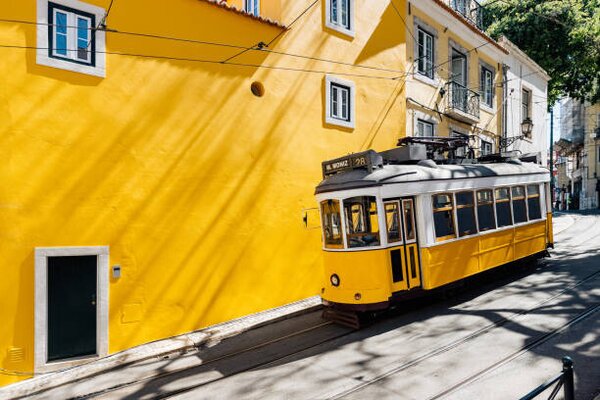 Photography Yellow tram moving past yellow building, Alexander Spatari