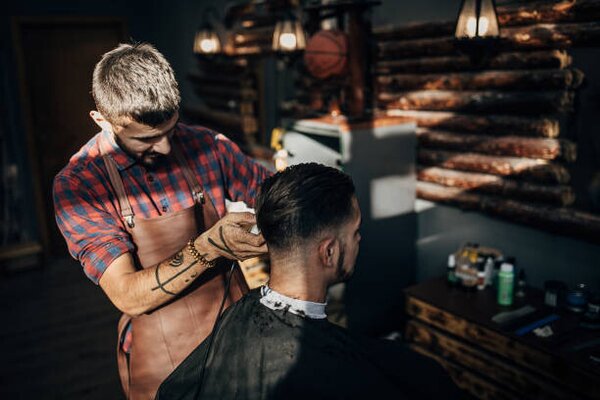 Photography One hairdresser cutting hair of a, South_agency