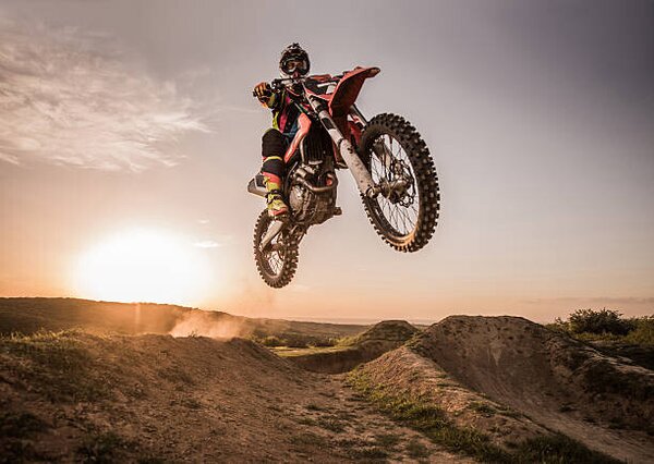 Photography Motocross rider performing high jump at sunset., skynesher